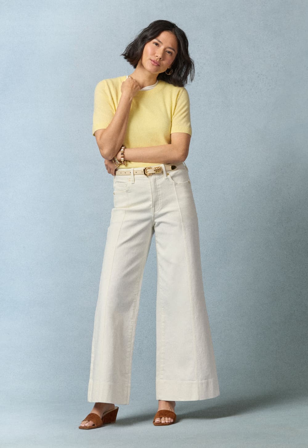 Image of woman wearing a yellow tee with ivory wide leg jeans.