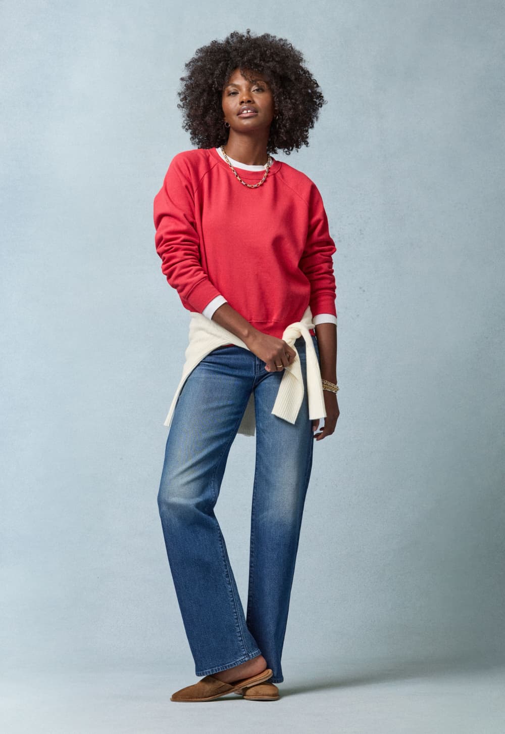 Image of woman wearing EVEREVE straight leg jeans and a red sweatshirt.