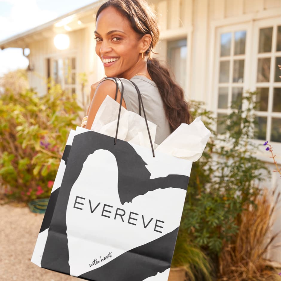 Image of a woman carrying an EVEREVE shopping bag