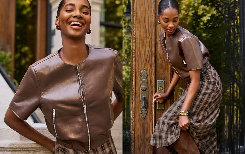 Woman wearing a plaid skirt with a short sleeve brown bomber jacket