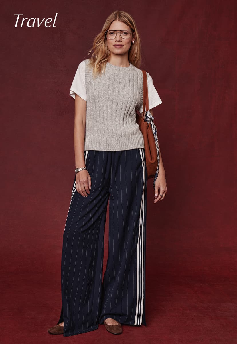 Image of woman wearing Tala Track Pants with grey sweater, Travel