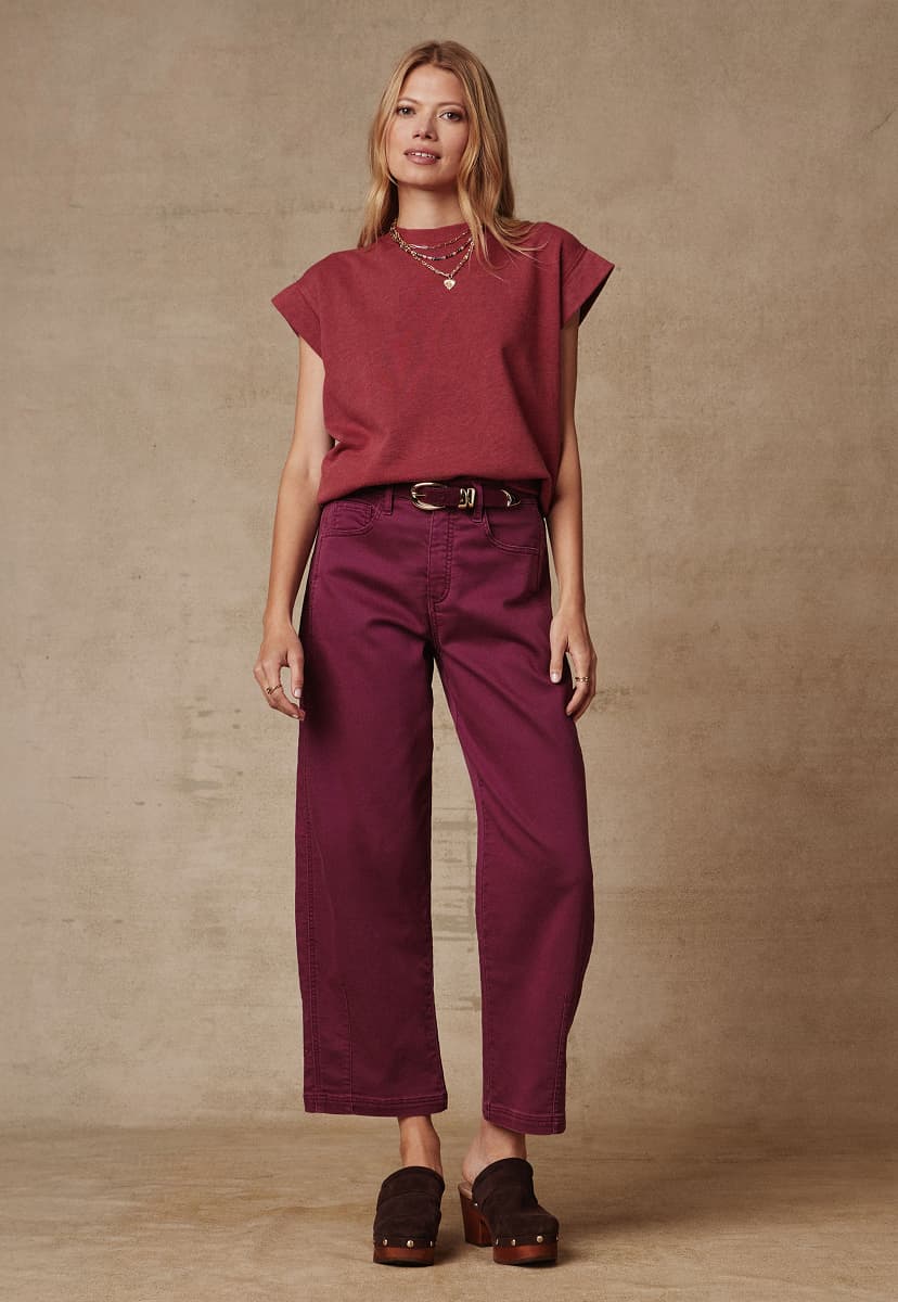 Image of woman wearing red Sutton sweatshirt and Marni pants