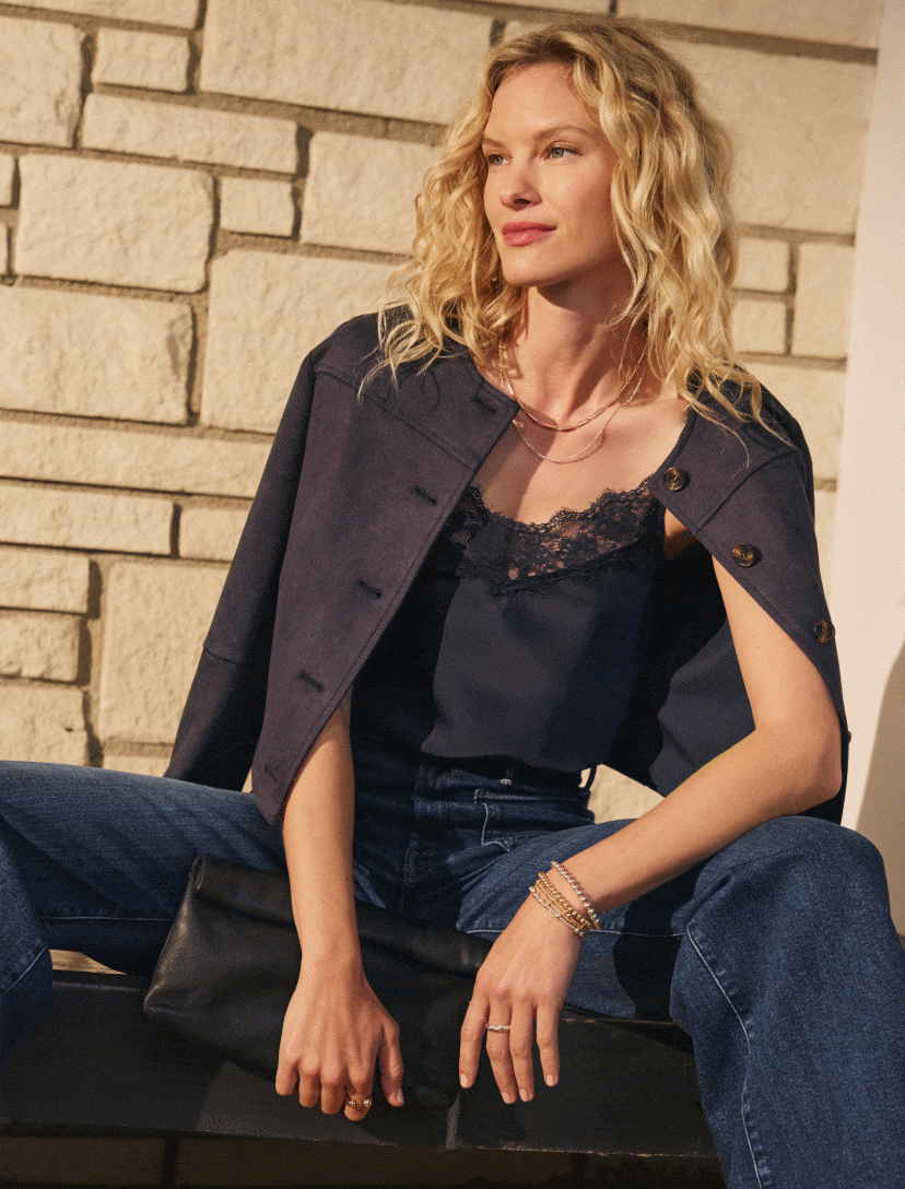 Image of woman wearing a navy Lakyn jacket in two different styles.