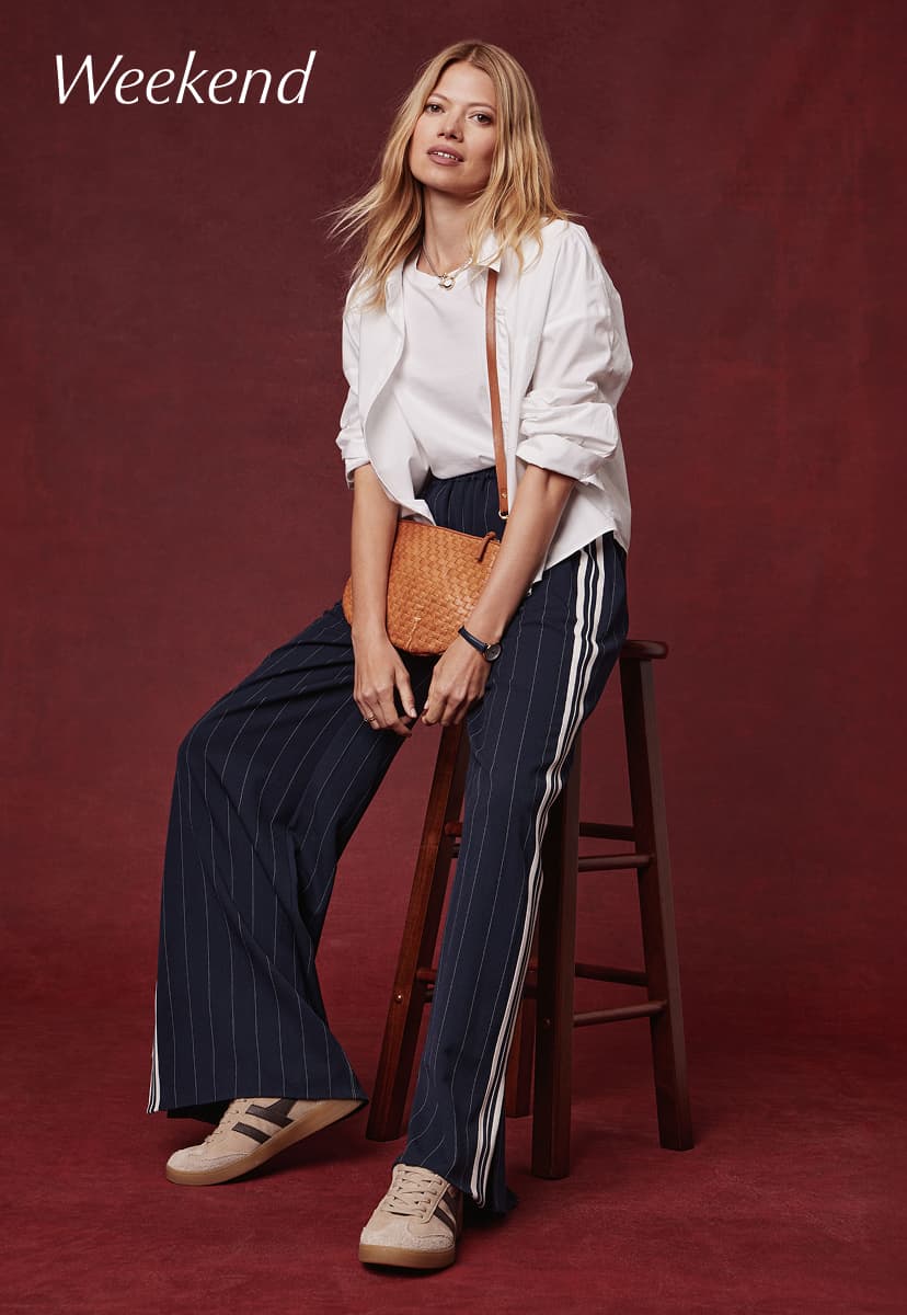 Image of woman wearing Tala Track Pants with white button down and sneakers