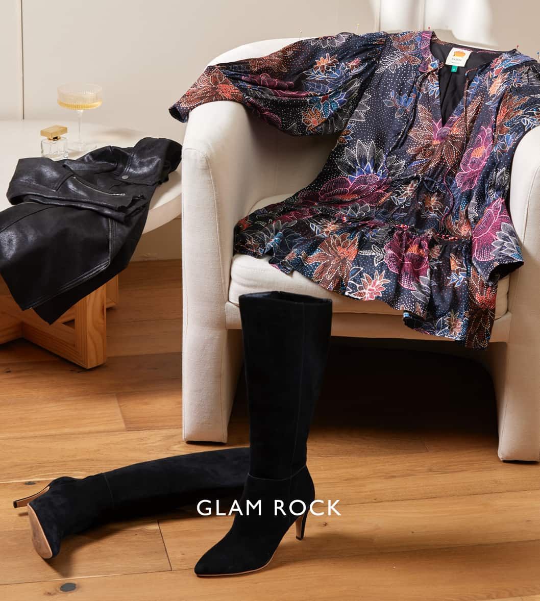 Image of a dark floral mini dress laid out on a chair with a black jacket on the table and knee high boots on the floor with the caption "Glam Rock"