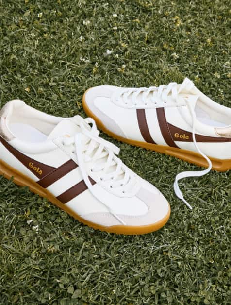Image of white Gola sneakers with brown stripes