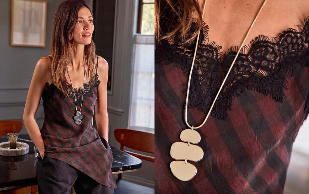 Woman wearing a stripe asymmetrical hem cami with black lace trim