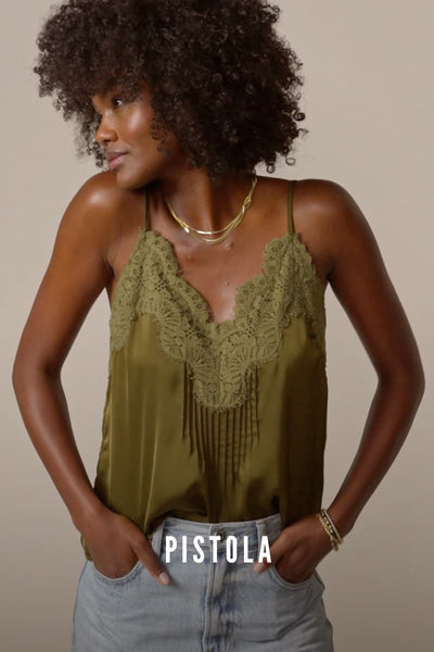 Video of woman wearing a green cami with Pistola barrel jeans. 