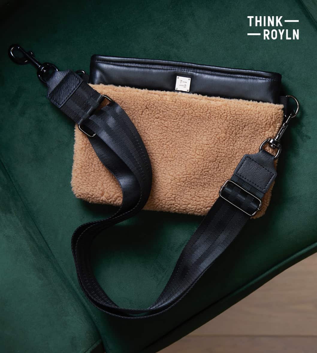 Image of a Think Royln black and brown faux shearling cross-body bag with the logo "THINK ROYLN"